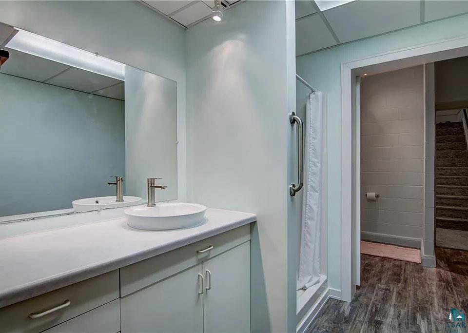6030 Mitchell Road Iron River, WI 54847 - Photo 20 of 45 Full bathroom featuring a shower stall, vanity, and dark wood-type flooring