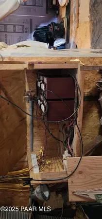 a room with water heater and wooden cabinets