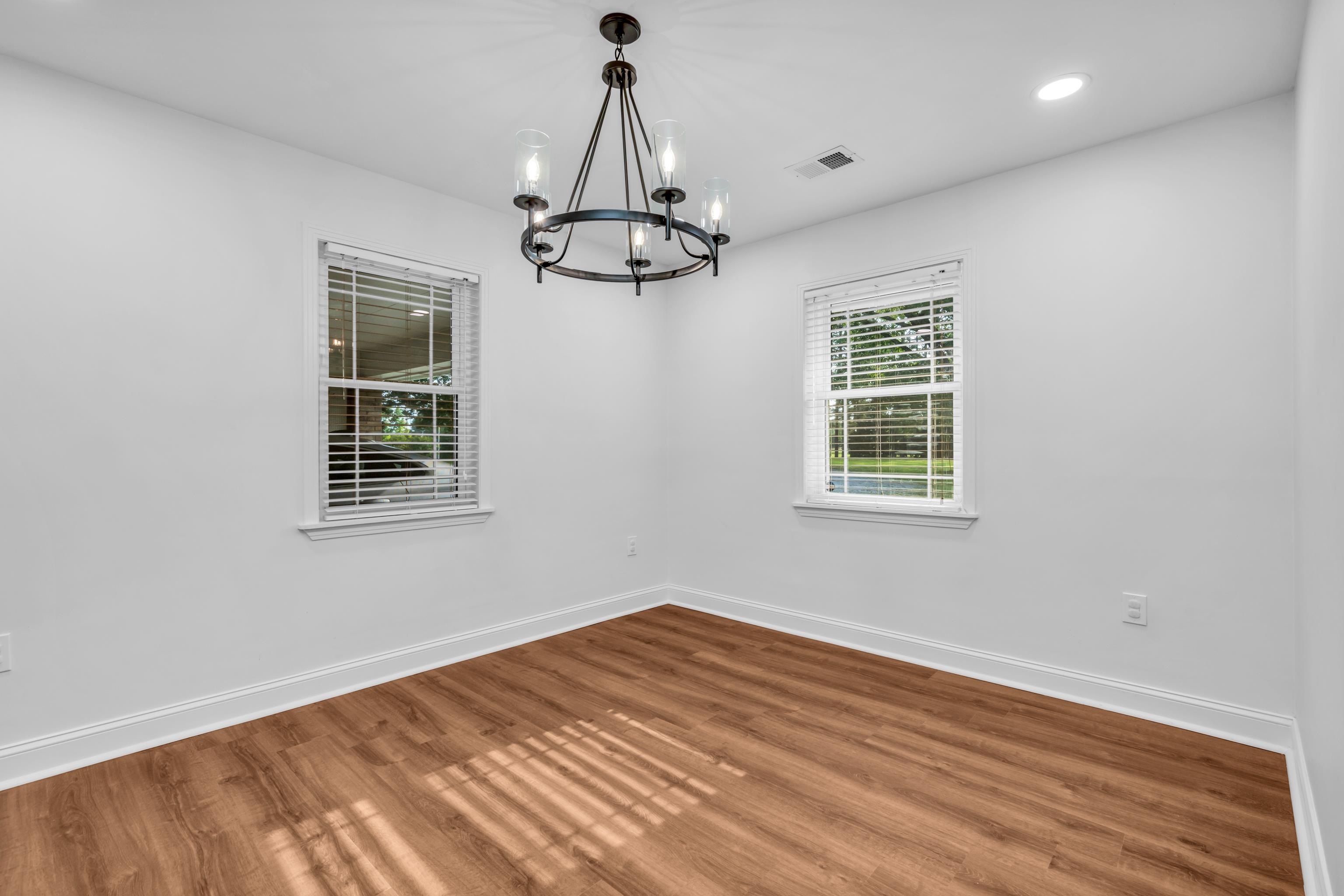 3890 Price Road Moscow, TN 38057 - Photo 8 of 37 Empty room with a chandelier, baseboards, wood finished floors, and recessed lighting
