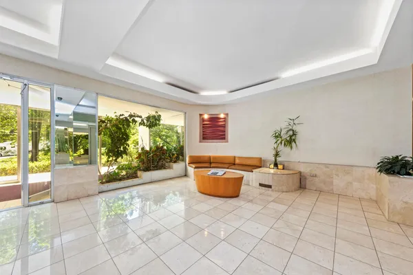 a room with patio furniture and a potted plant