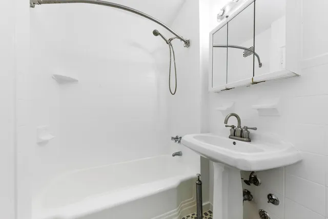 a bathroom with a sink a shower and a mirror