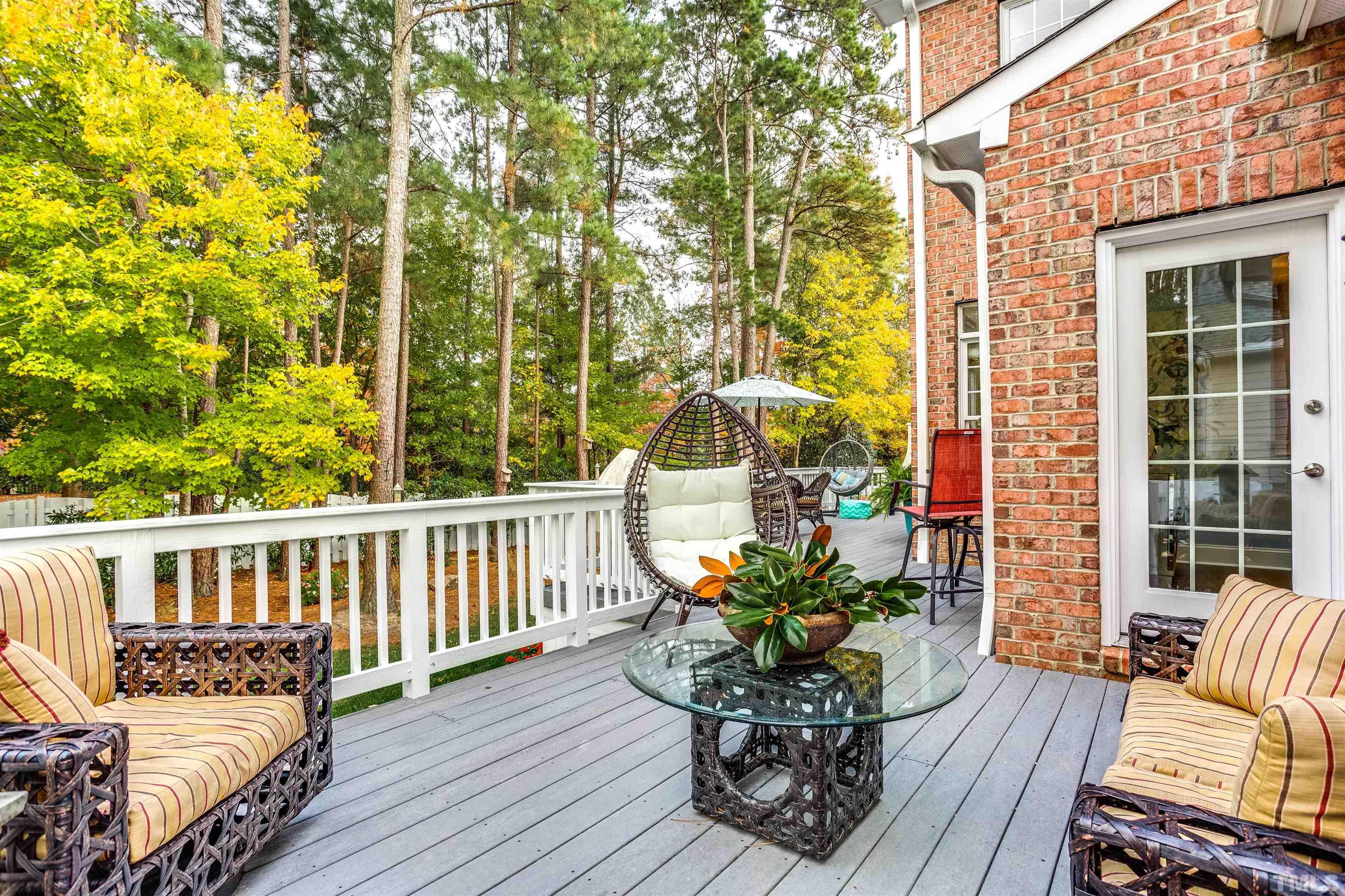 11313 Ridgegate Drive Raleigh, NC 27617 - Photo 23 of 82 a view of a chair and table on the wooden deck