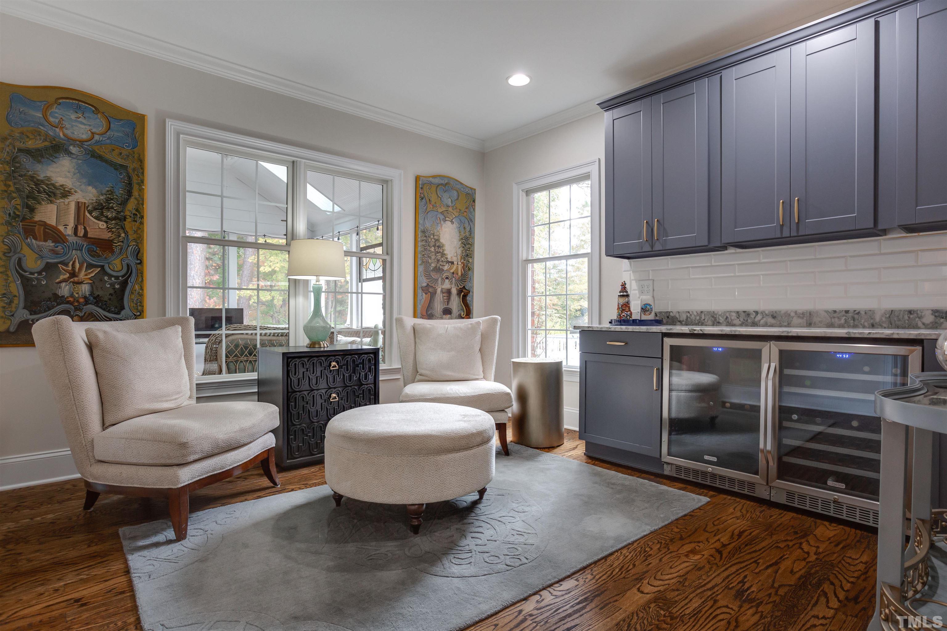 11313 Ridgegate Drive Raleigh, NC 27617 - Photo 31 of 82 a living room with furniture a large window and wooden floor