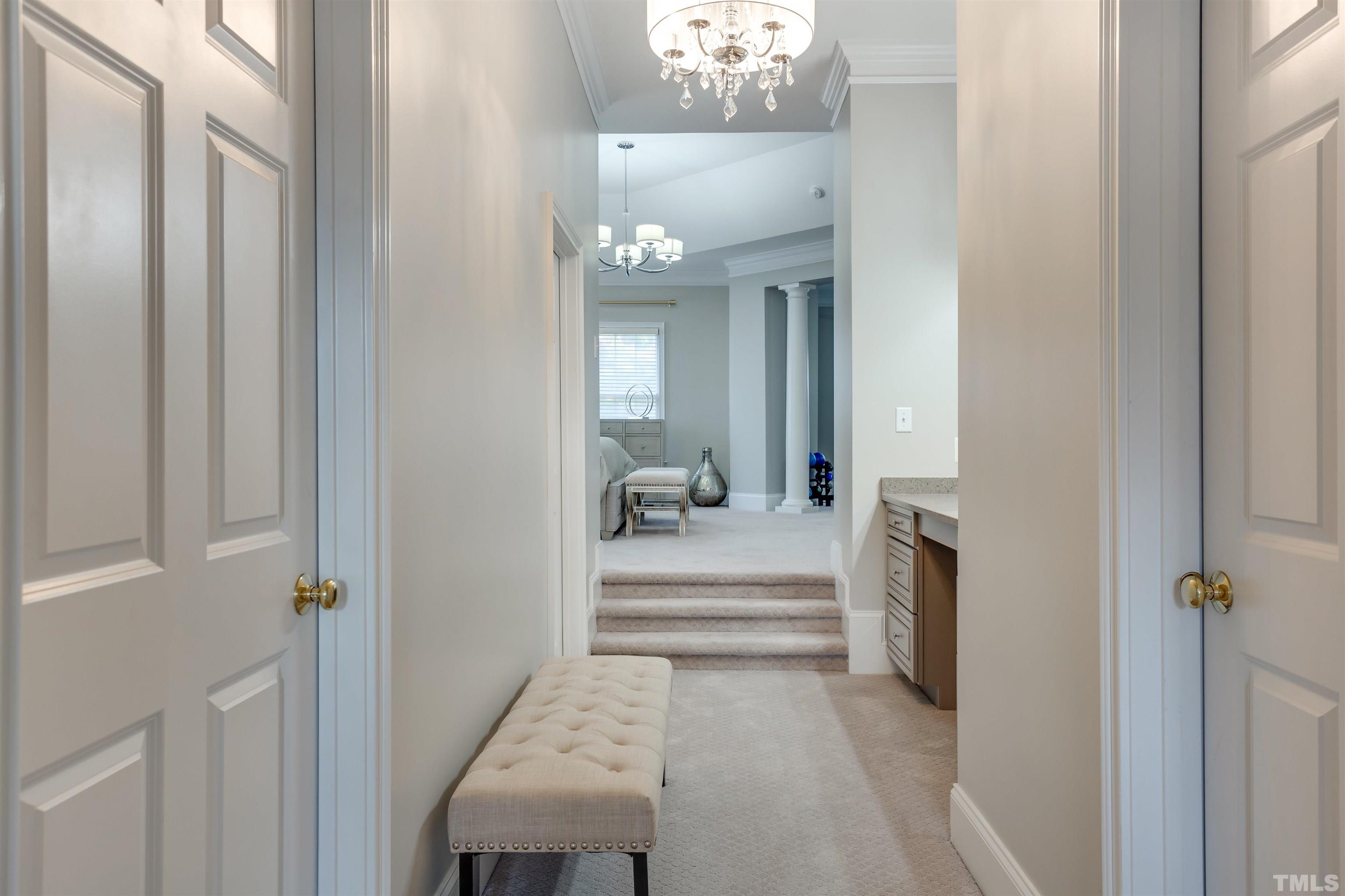 11313 Ridgegate Drive Raleigh, NC 27617 - Photo 65 of 82 a view of a hallway with a livingroom and a bathroom with mirror