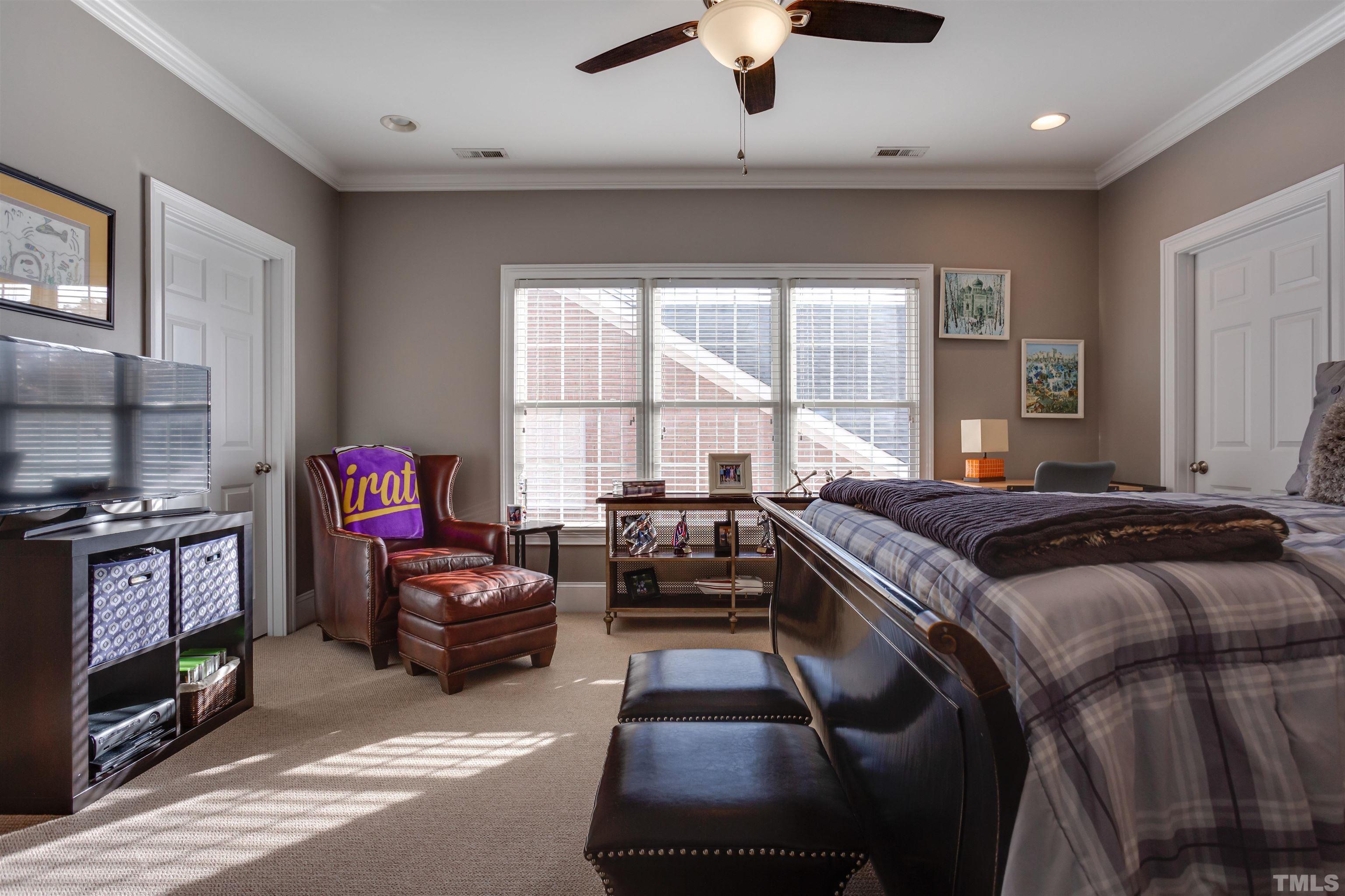 11313 Ridgegate Drive Raleigh, NC 27617 - Photo 74 of 82 a bedroom with a bed furniture and a flat screen tv