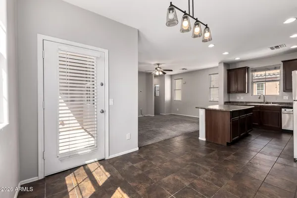 a kitchen with kitchen island granite countertop a sink and a stove
