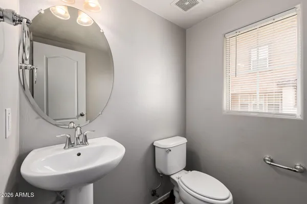 a bathroom with a sink toilet and mirror