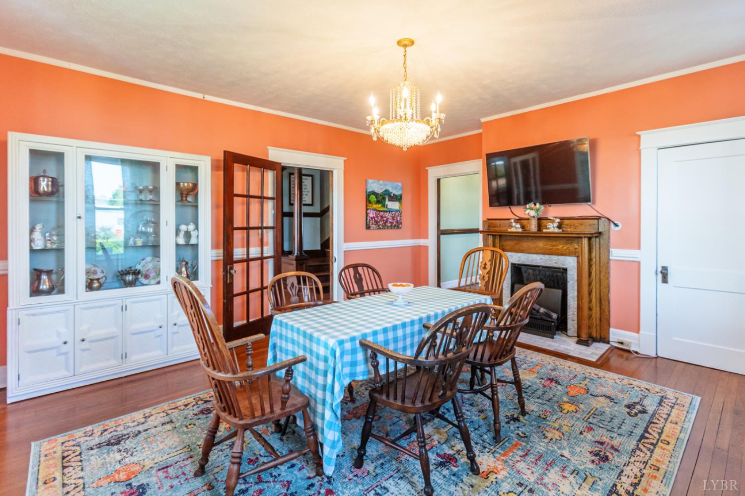 151 Burke Street Appomattox, VA 24522 - Photo 18 of 75 a dining room with furniture a rug a fireplace and a chandelier