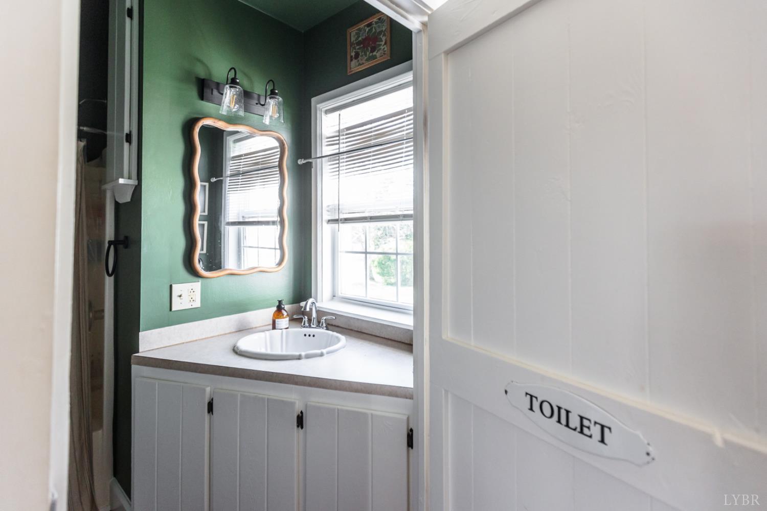 151 Burke Street Appomattox, VA 24522 - Photo 34 of 75 a bathroom with a sink and a mirror