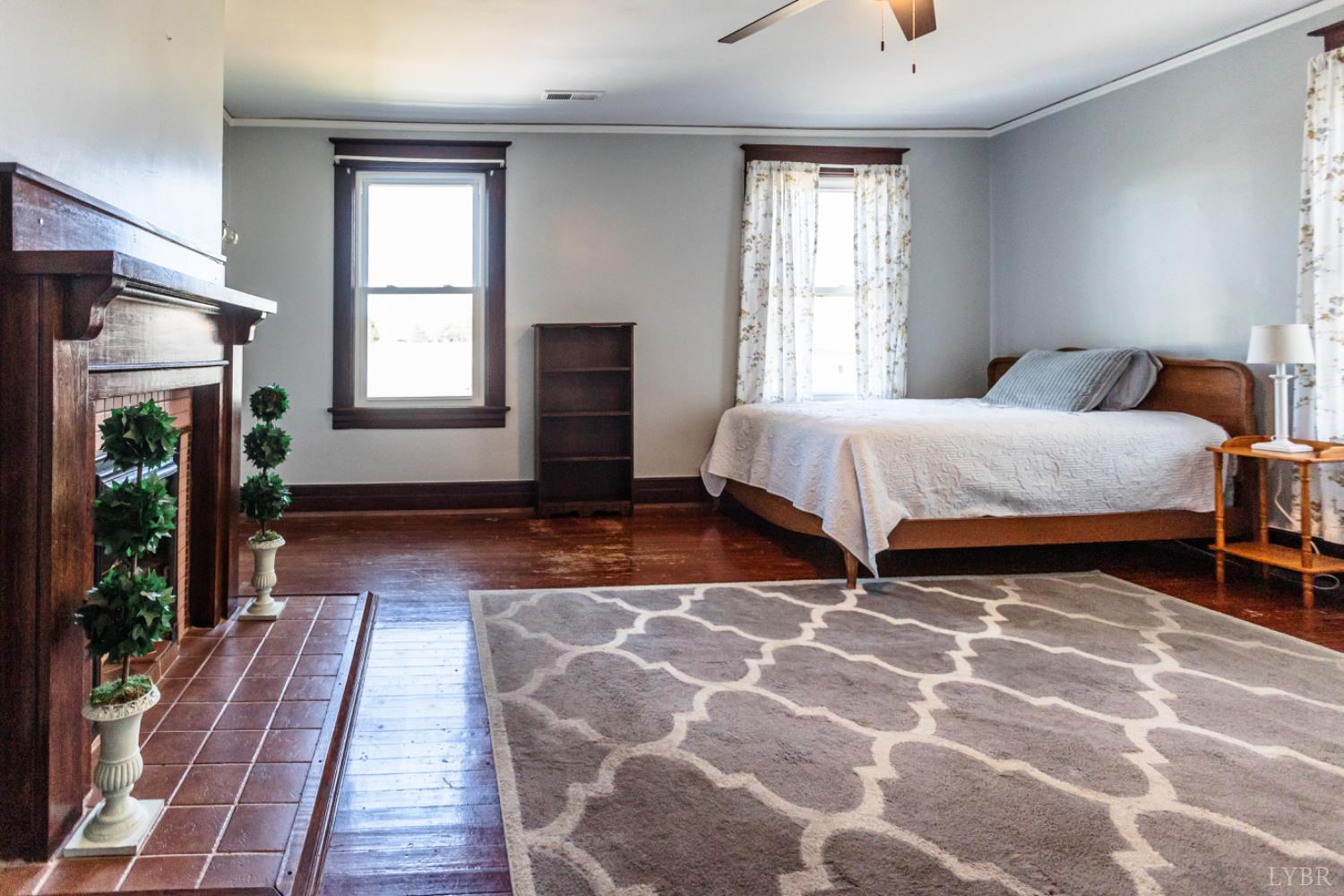 151 Burke Street Appomattox, VA 24522 - Photo 56 of 75 a bedroom with a bed and a fireplace