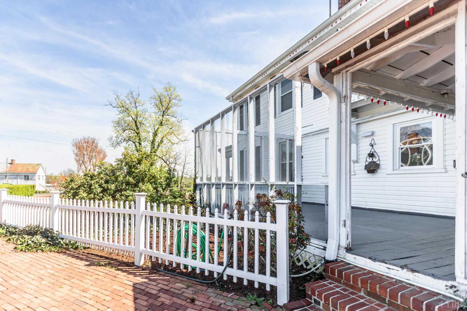 151 Burke Street Appomattox, VA 24522 - Photo 68 of 75 a porch with a bench next to a yard