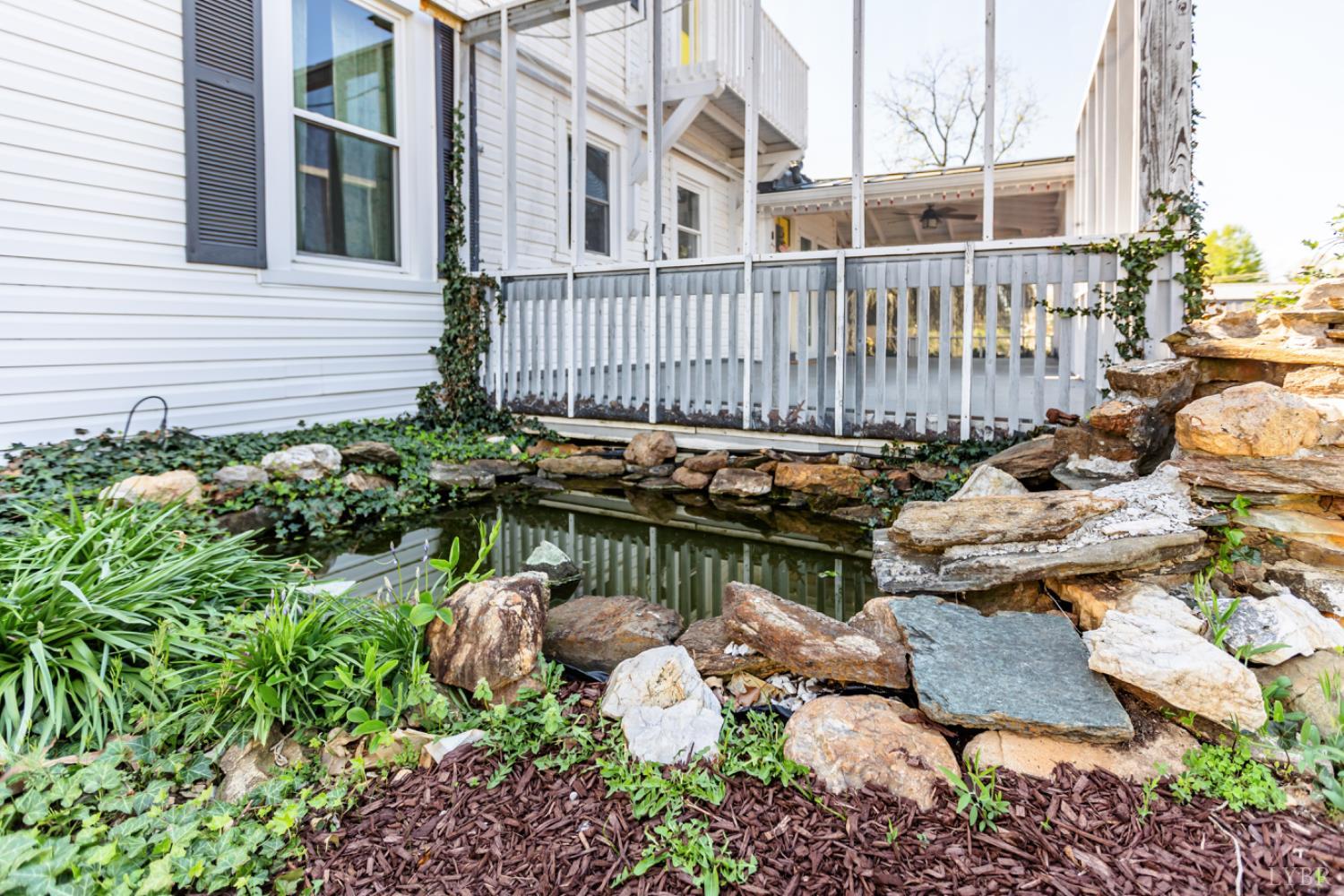 151 Burke Street Appomattox, VA 24522 - Photo 72 of 75 a backyard of a house with lots of green space and fountain
