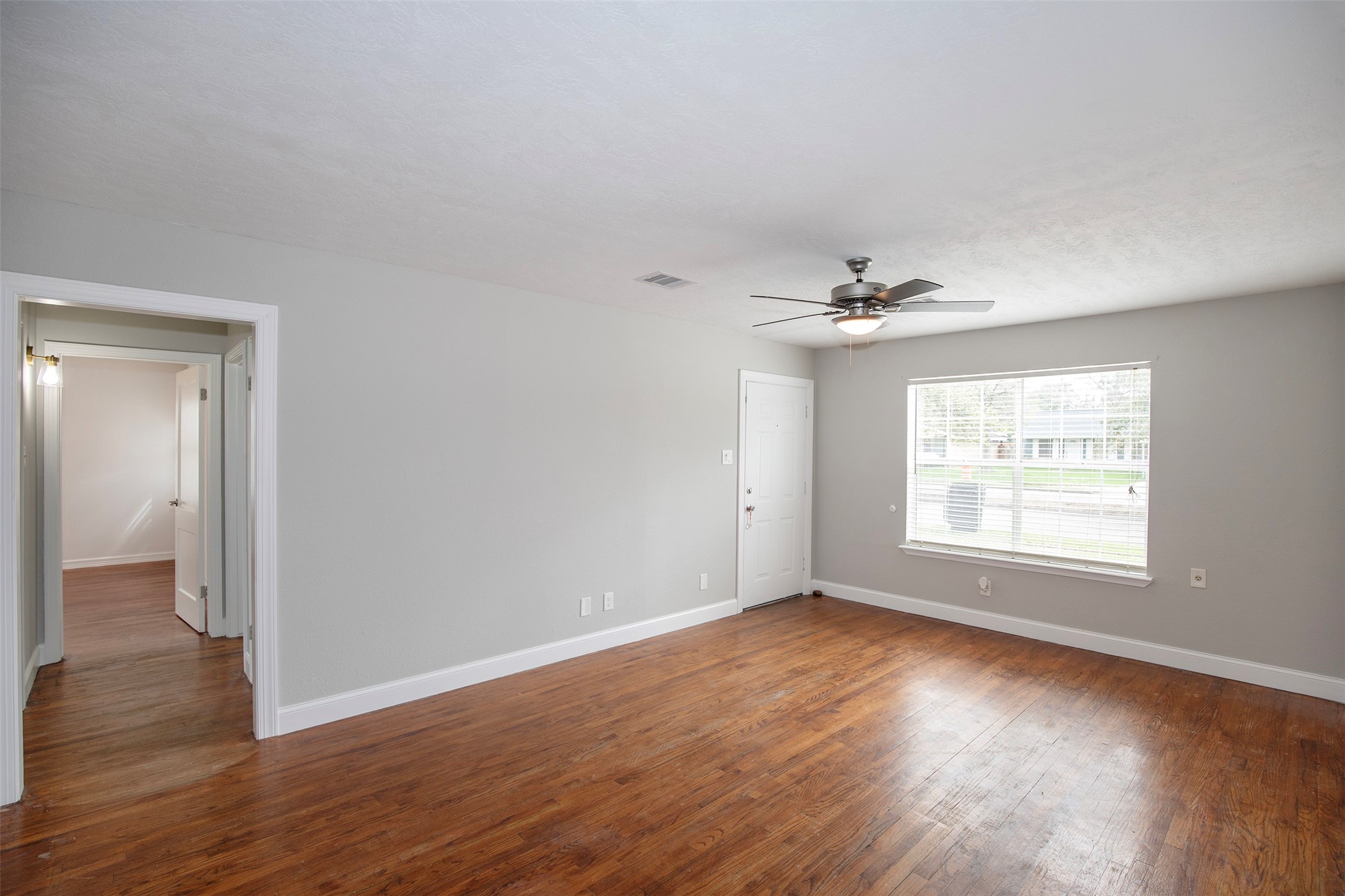 The family room has a large window that allows the natural light to flow through the room.