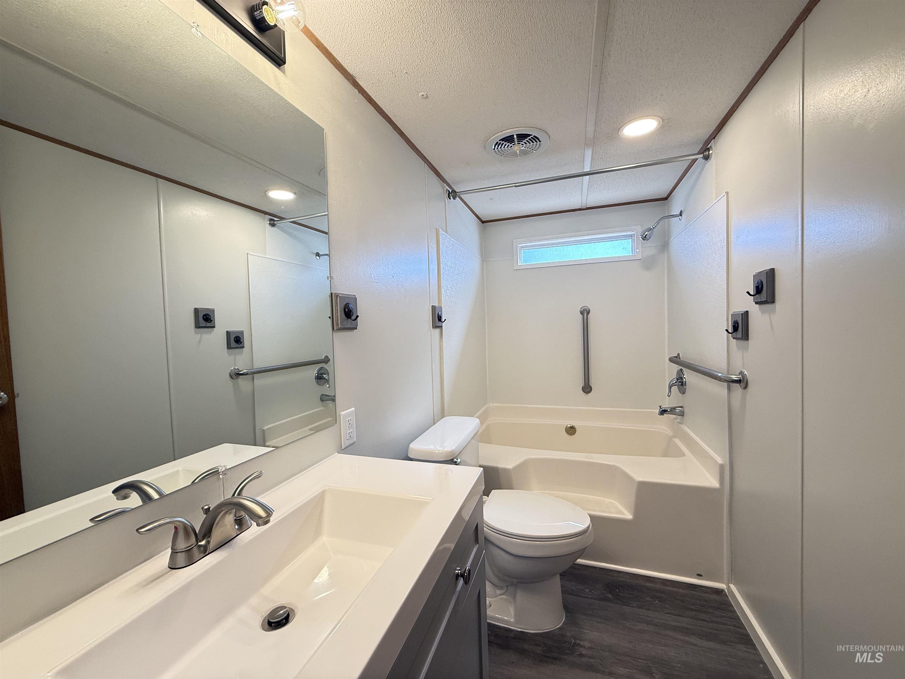 2015 6th Avenue, Unit 321 Clarkston, WA 99403 - Photo 12 of 34 Bathroom featuring vanity, recessed lighting, shower / washtub combination, dark wood finished floors, and a textured ceiling