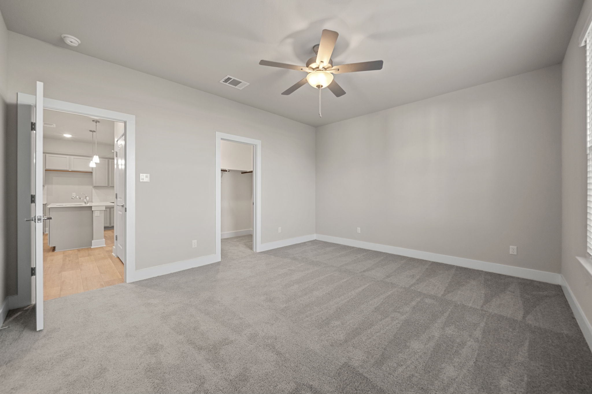 219 Pinnacle Lane Kyle, TX 78640 - Photo 10 of 20 an empty room with chandelier fan and glass door