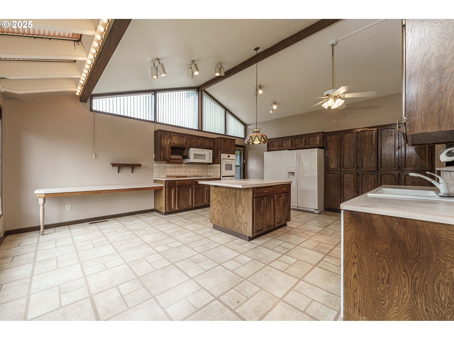 26690 Southeast Kelso Road Boring, OR 97009 - Photo 11 of 48 a kitchen with stainless steel appliances kitchen island a large counter space a sink and a stove