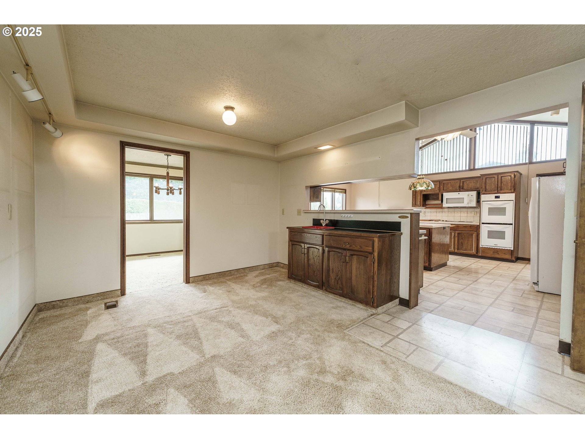 26690 Southeast Kelso Road Boring, OR 97009 - Photo 15 of 48 a large kitchen with stainless steel appliances granite countertop a granite counter tops and a view of living room