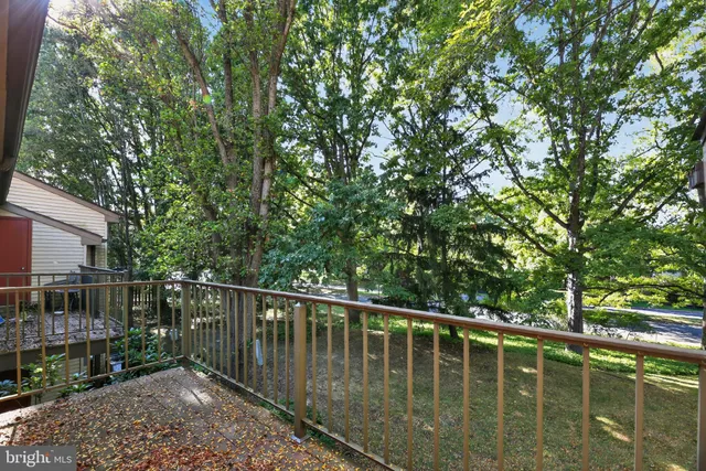 a view of balcony with wooden floor and fence