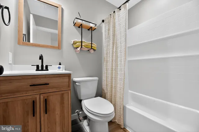 a bathroom with a toilet sink and shower