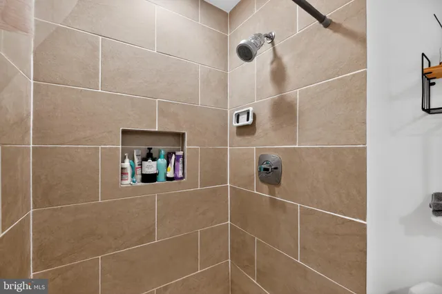 a bathroom with a shower and a mirror