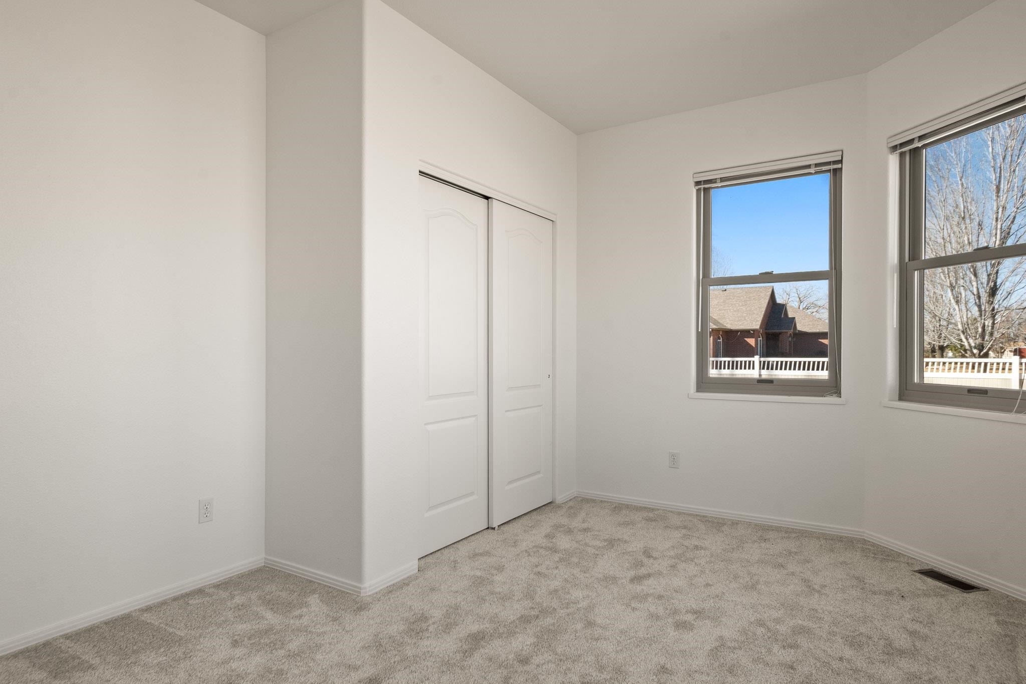 2107 I I- 1/2 Road Grand Junction, CO 81505 - Photo 14 of 42 an empty room with windows and closet