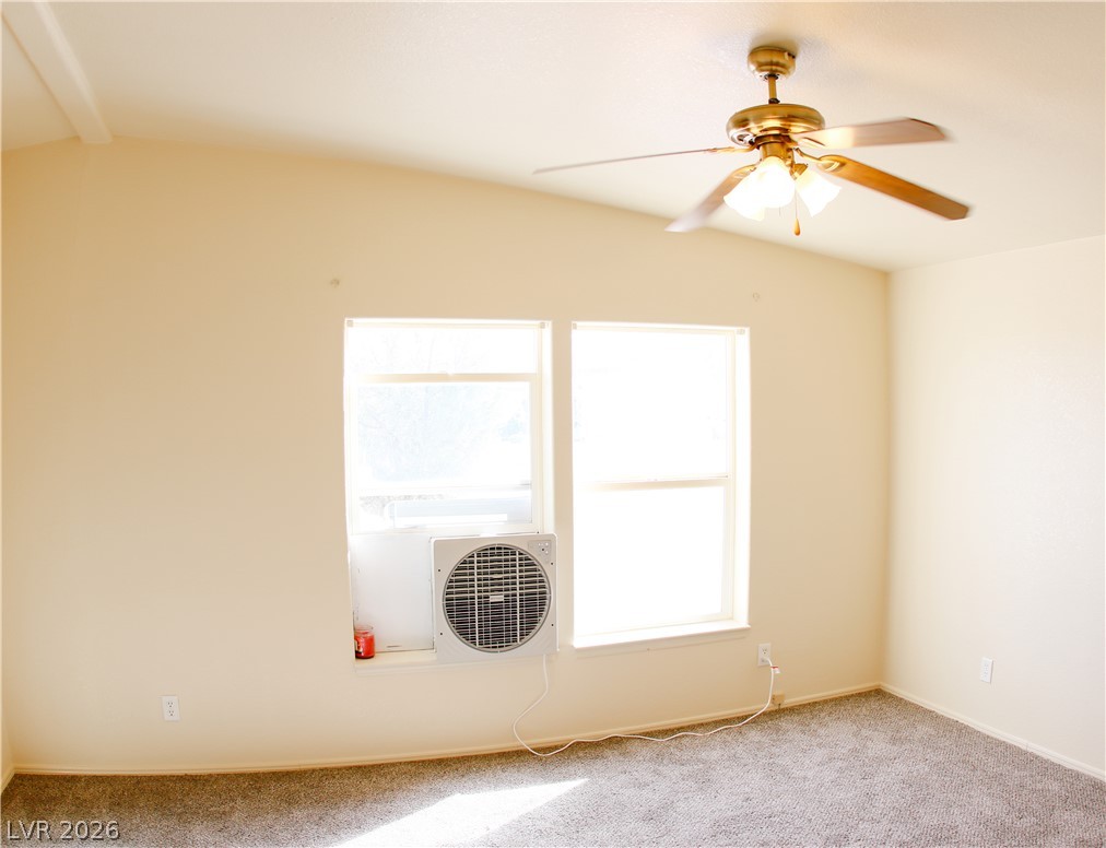 5231 Ruby Way Caliente, NV 89008 - Photo 20 of 35 Well-lit room features a vaulted ceiling and soft carpet underfoot, with ample natural light.