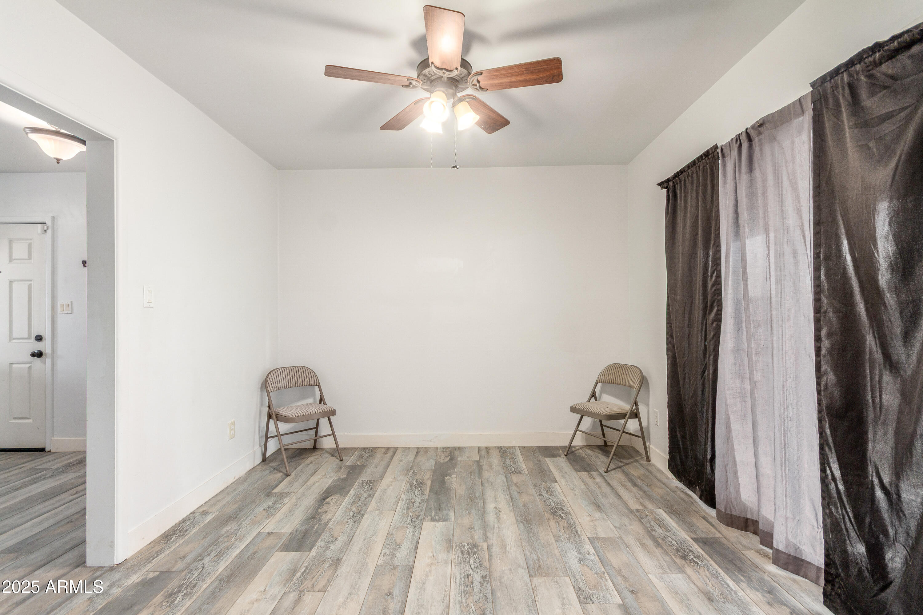 413 East 3rd Street Eloy, AZ 85131 - Photo 15 of 44 a view of room with wooden floor and fan