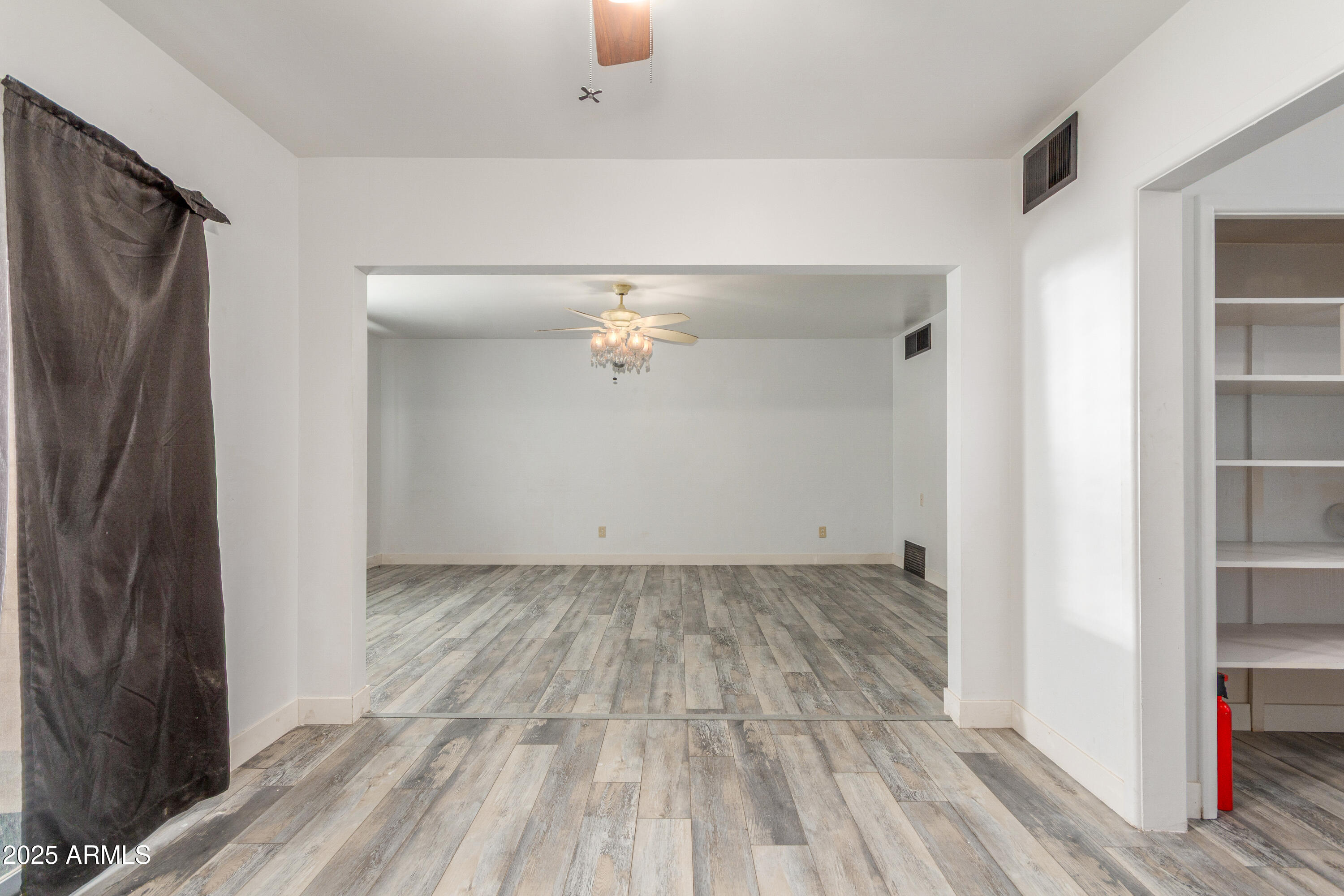 413 East 3rd Street Eloy, AZ 85131 - Photo 16 of 44 a view of a room with wooden floor and a window