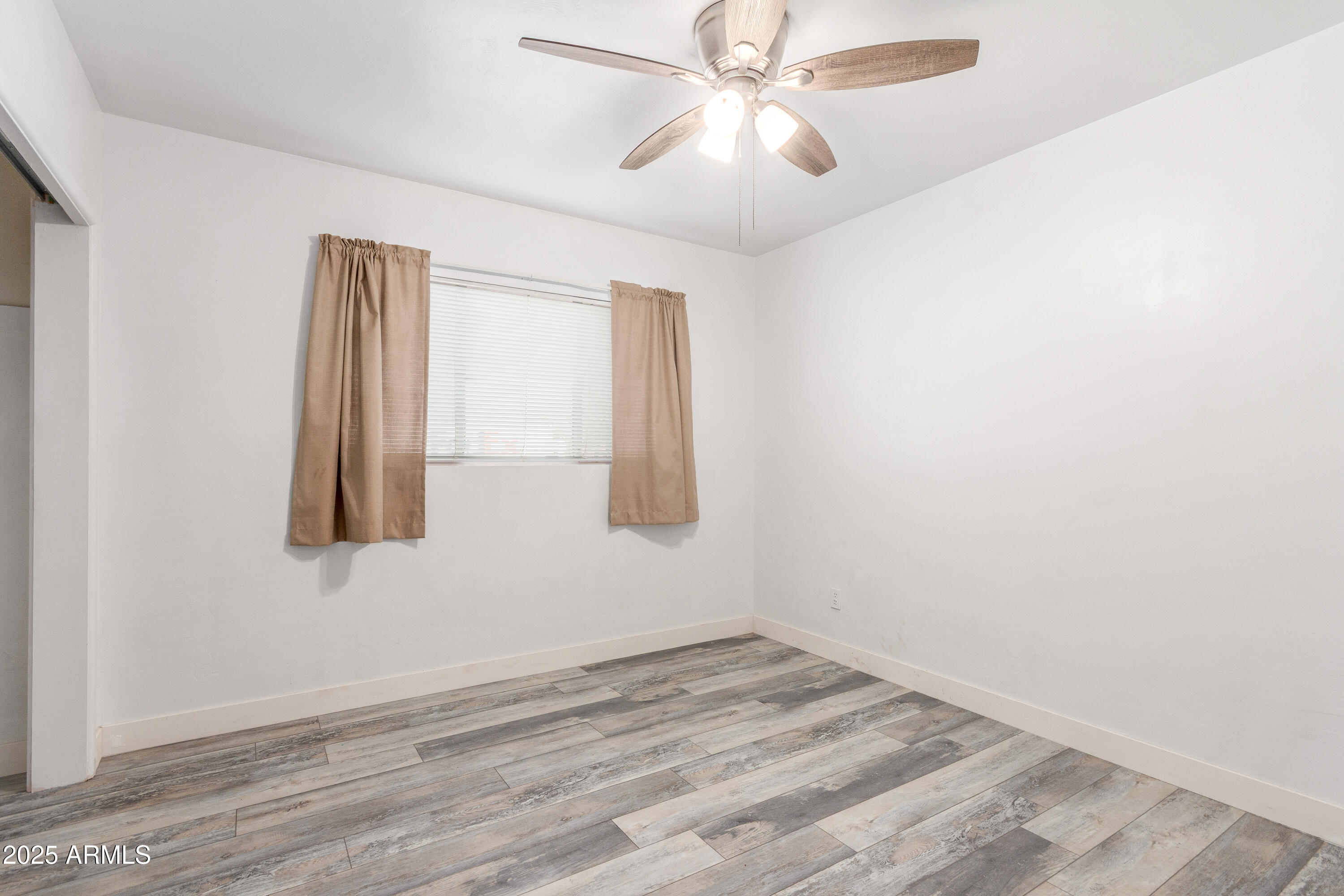 413 East 3rd Street Eloy, AZ 85131 - Photo 25 of 44 an empty room with windows and fan