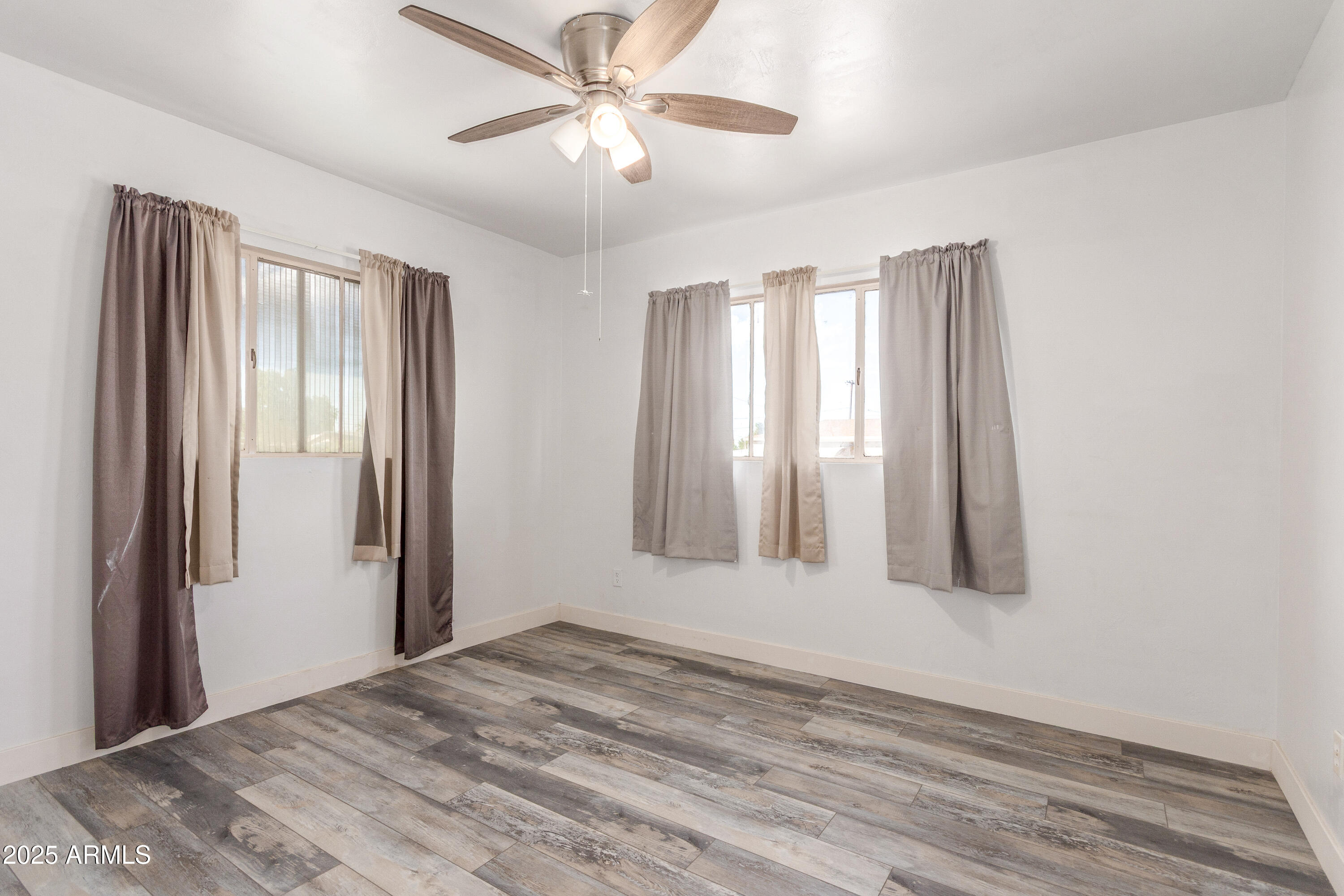413 East 3rd Street Eloy, AZ 85131 - Photo 27 of 44 a view of a room with wooden floor and windows