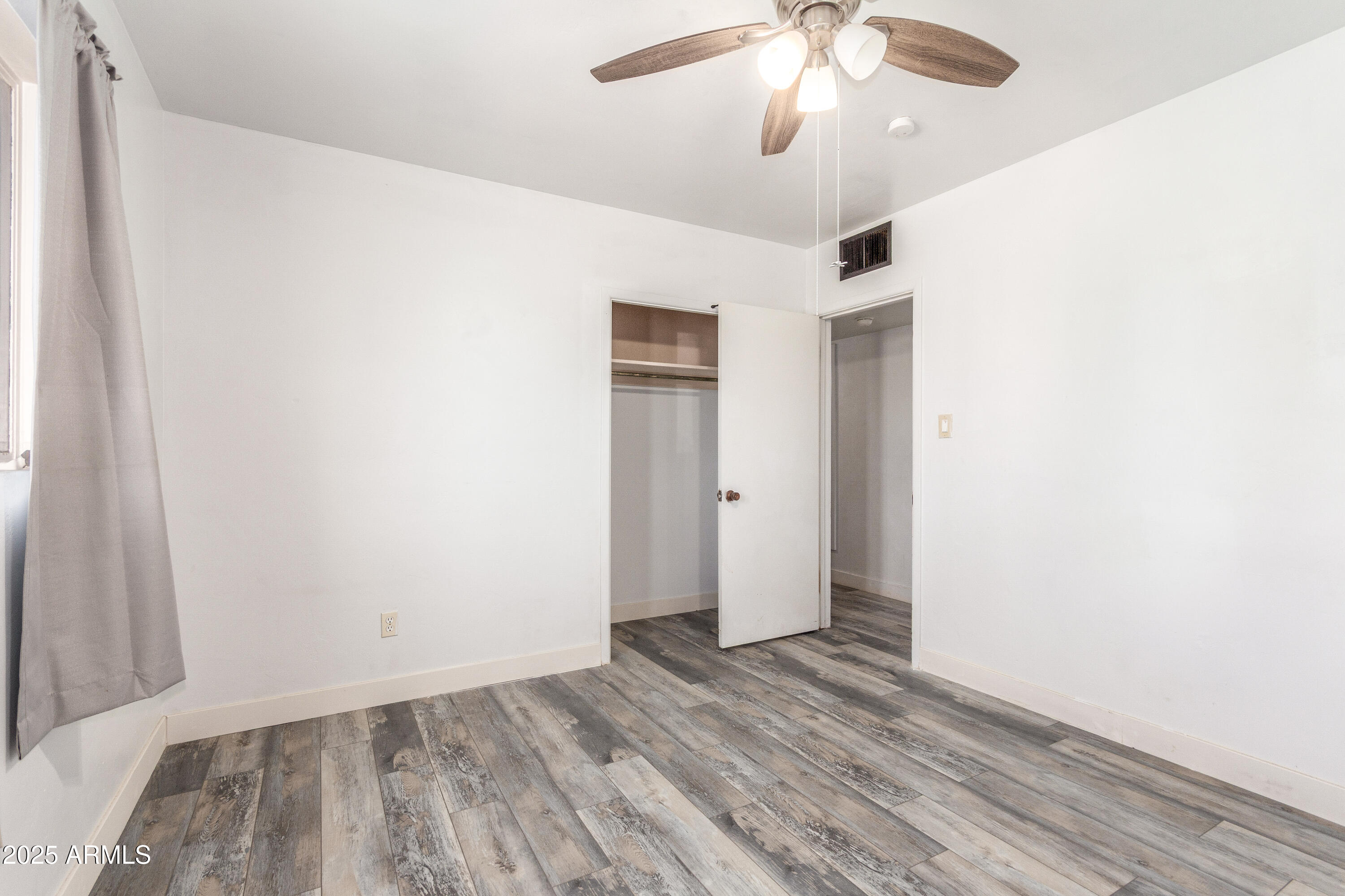 413 East 3rd Street Eloy, AZ 85131 - Photo 28 of 44 a view of an empty room with wooden floor