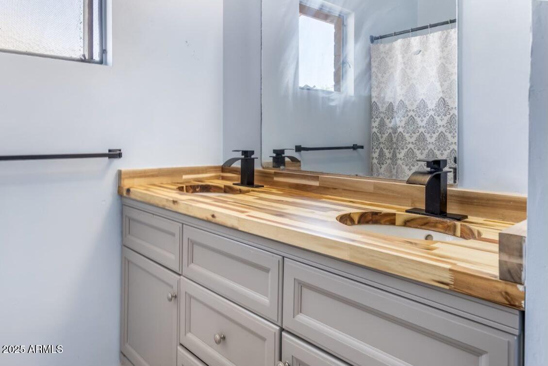413 East 3rd Street Eloy, AZ 85131 - Photo 29 of 44 a bathroom with a sink and a mirror