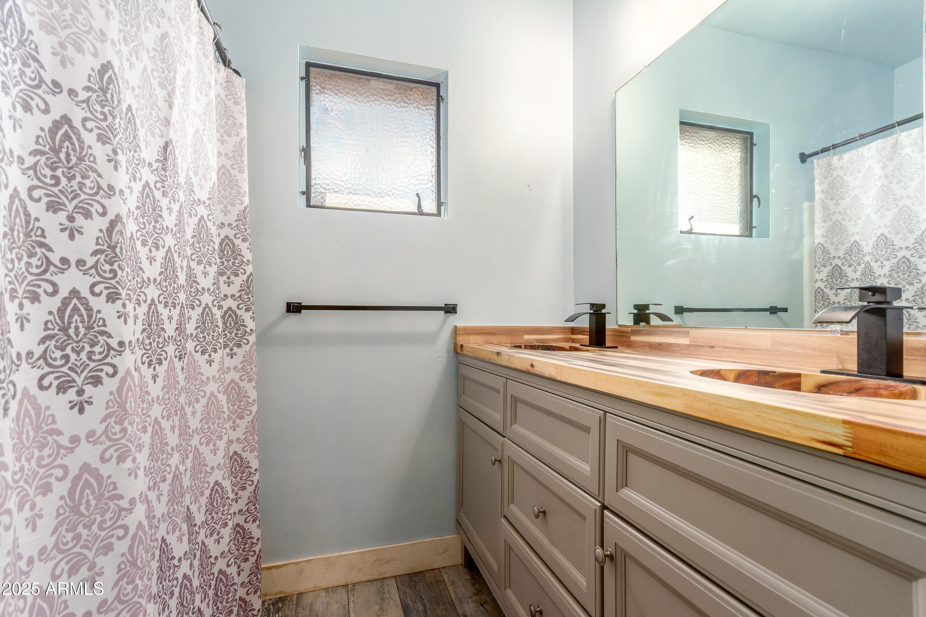 413 East 3rd Street Eloy, AZ 85131 - Photo 30 of 44 a bathroom with a granite countertop sink and a mirror