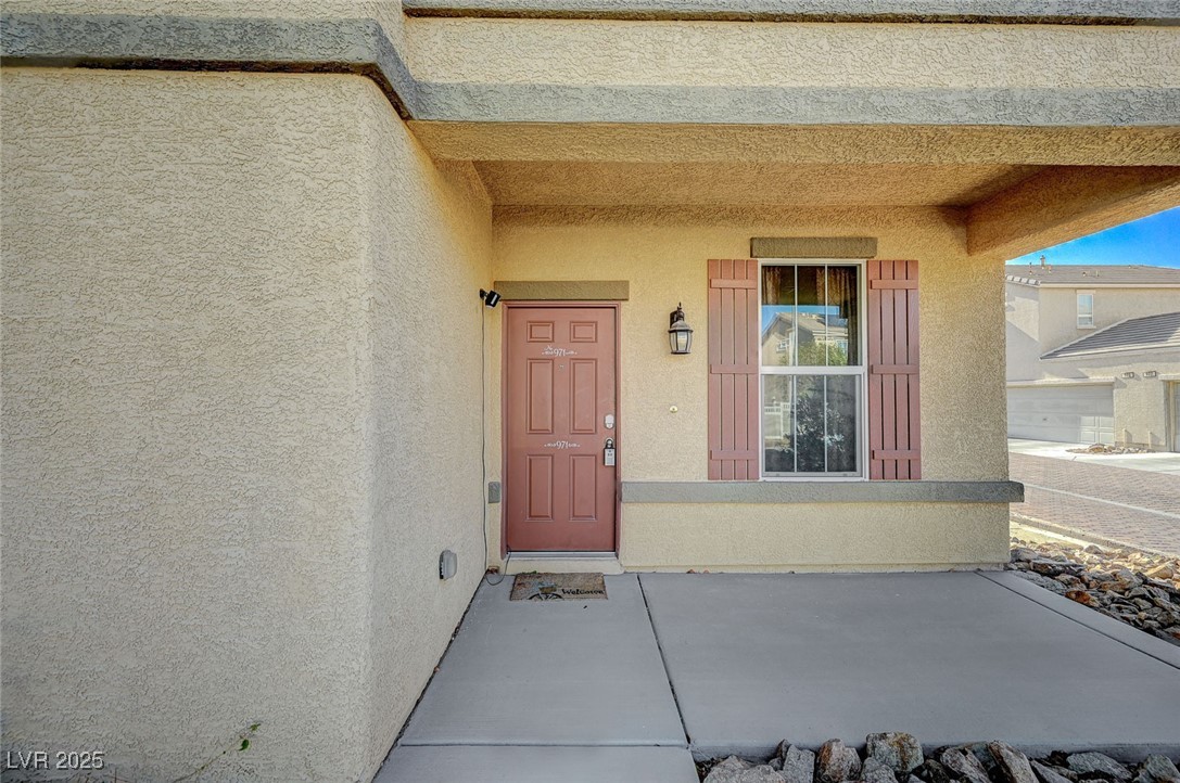 971 Sable Chase Place Henderson, NV 89011 - Photo 4 of 48 View of exterior entry with stucco siding