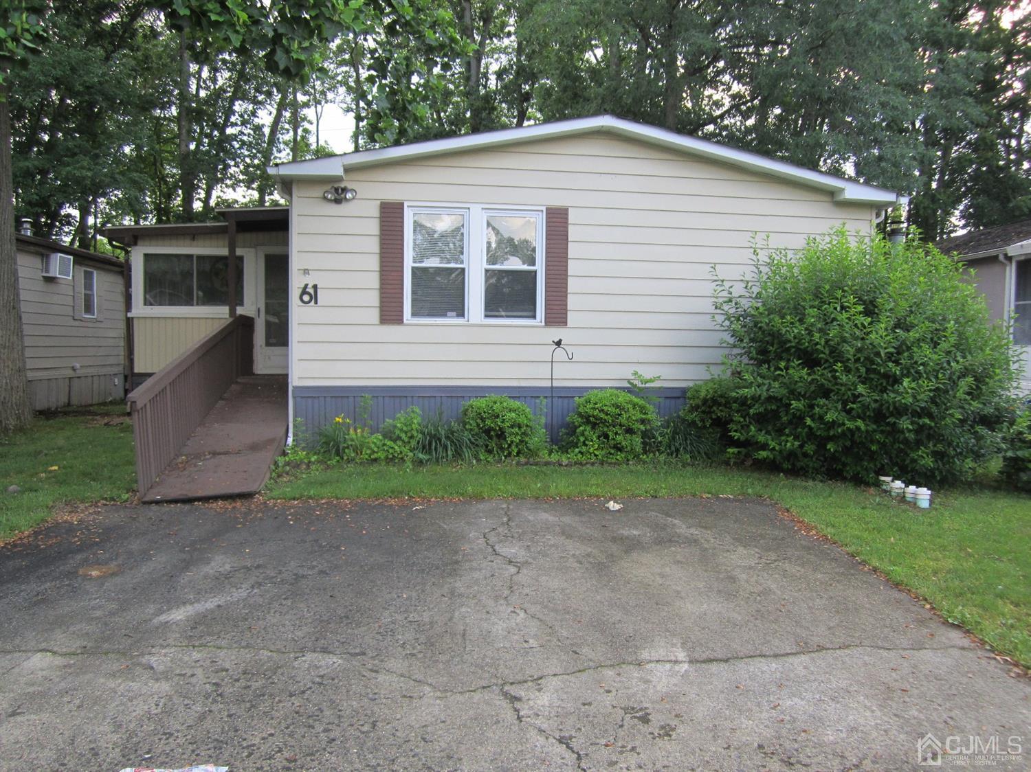 61 Whitman Road North Brunswick, NJ 08902 - Photo 1 of 16 Front of house, 2 car driveway, side enclosed porch.