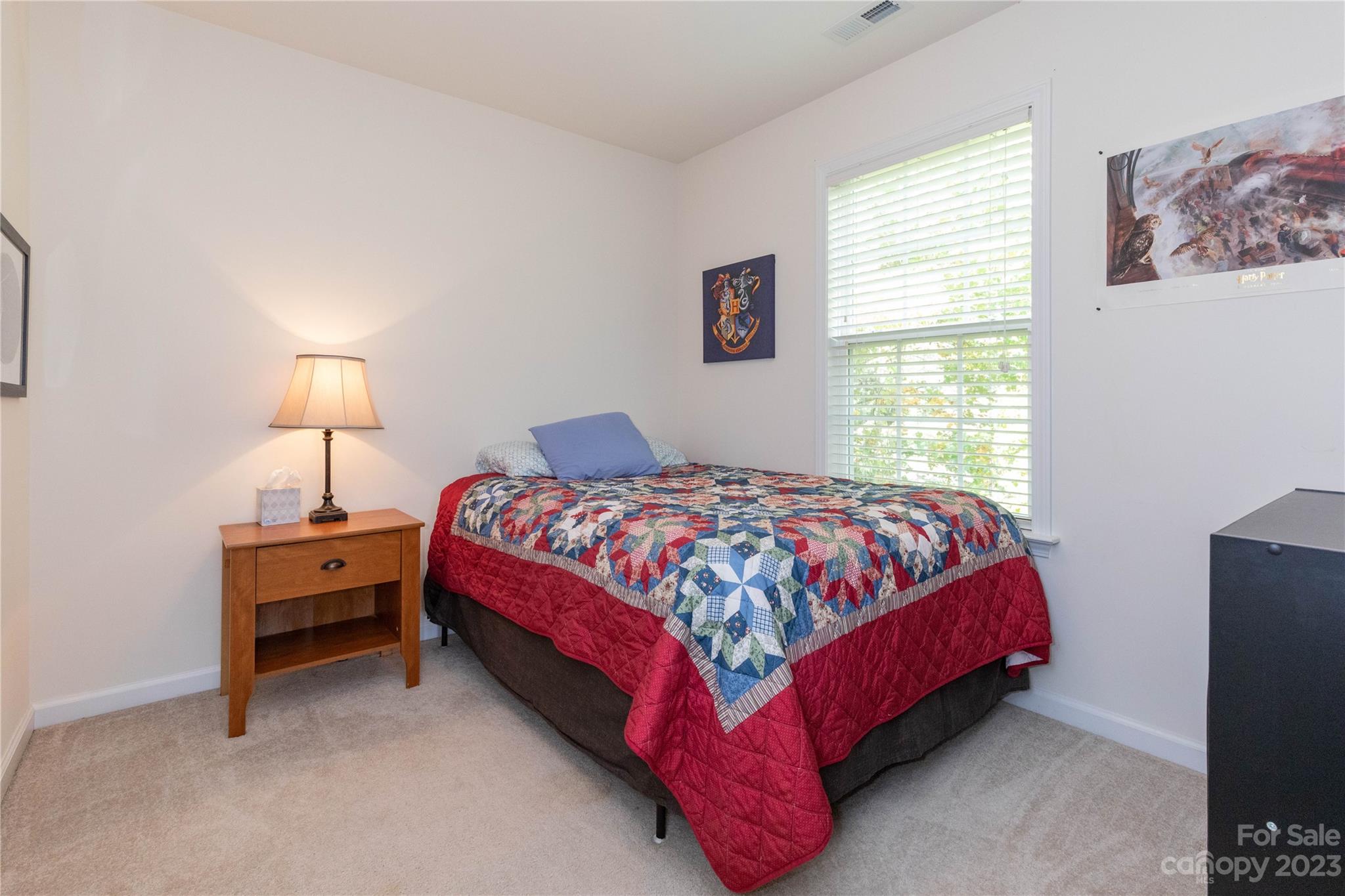 101 Ledbetter Road Arden, NC 28704 - Photo 15 of 21 a bedroom with a bed and a lamp next to a window