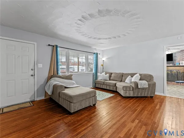 a bedroom with furniture and wooden floor