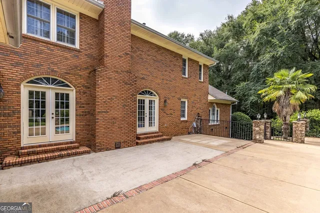a view of a house with a yard and sitting area