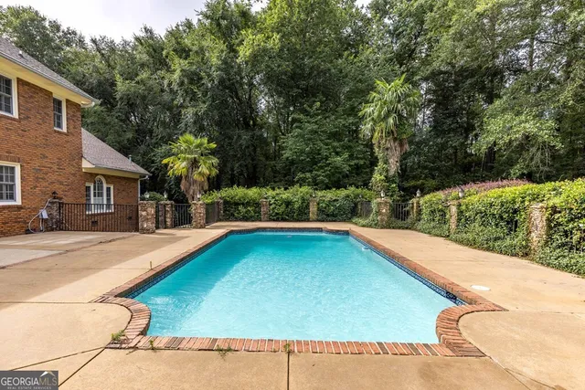 a view of a park with a bench and trees