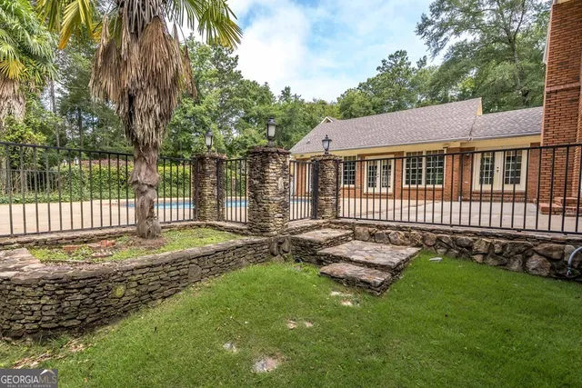 a view of empty room with wooden floor and fireplace
