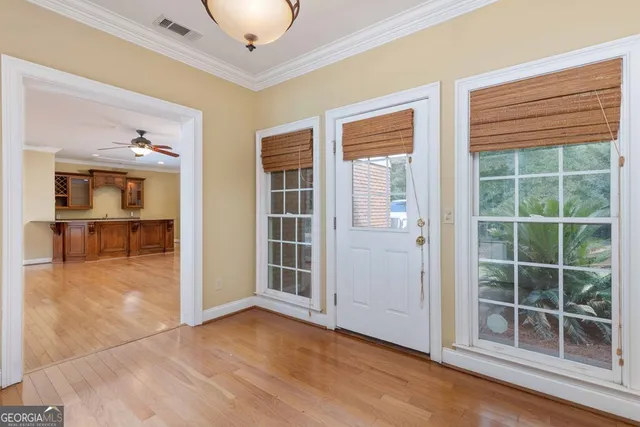 a view of entryway with wooden floor and stairs