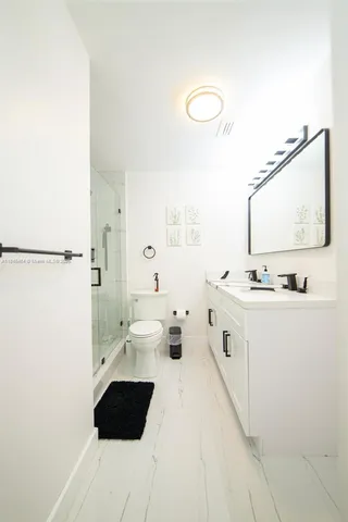 a bathroom with a double vanity sink and mirror
