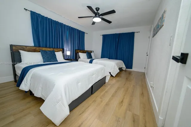 a bedroom with bed and wooden floor