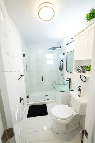 a bathroom with a toilet a sink a bathtub a mirror and vanity