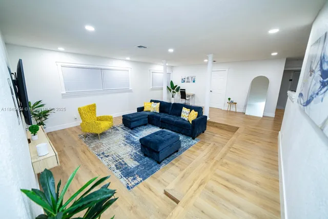 a living room with furniture and a potted plant