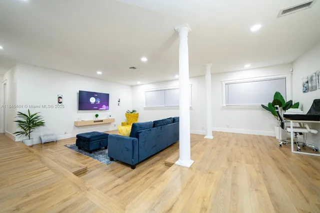 a living room with furniture and a potted plant