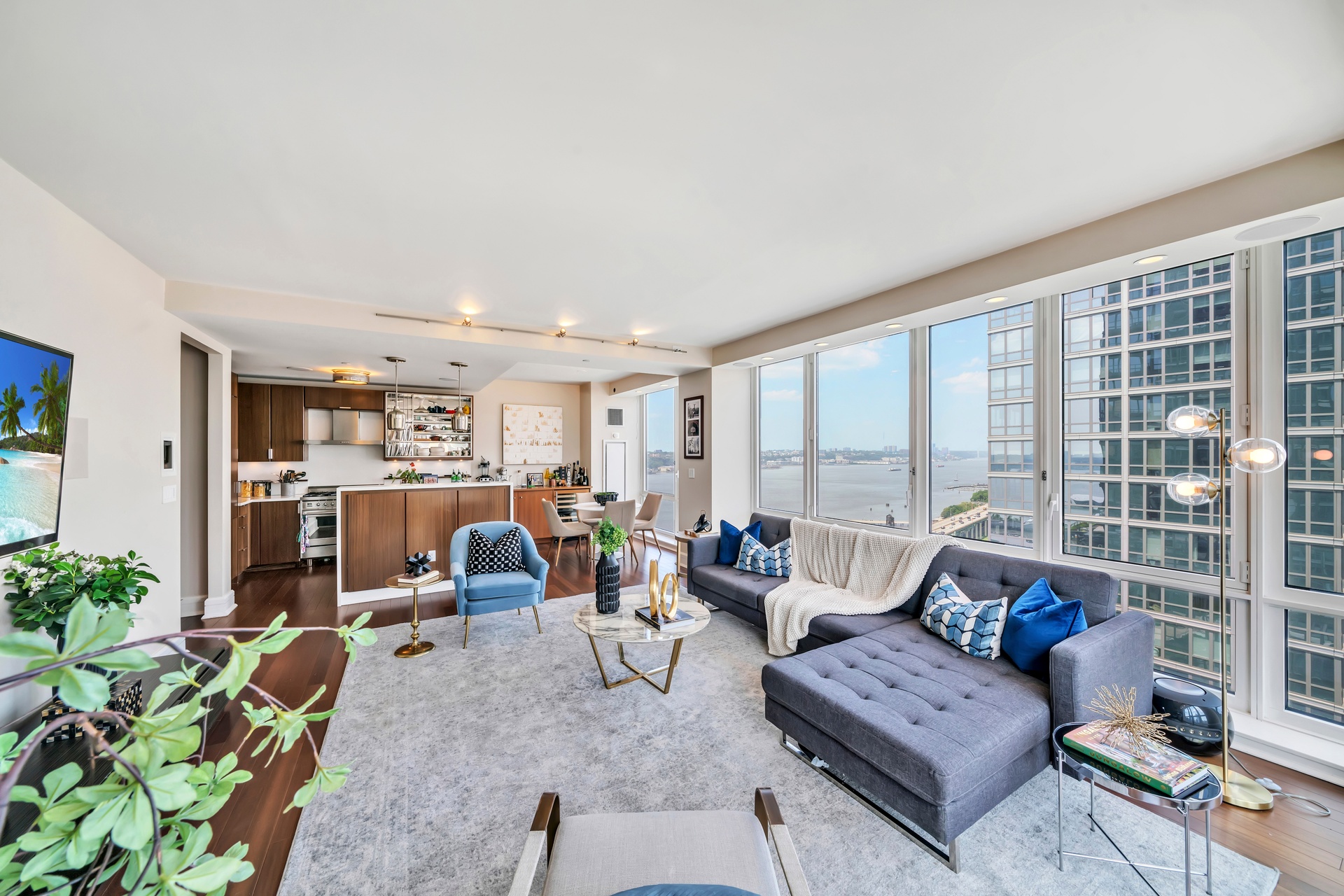 60 Riverside Boulevard, Unit 2402 Manhattan, NY 10069 - Photo 4 of 23 a living room with furniture and a floor to ceiling window