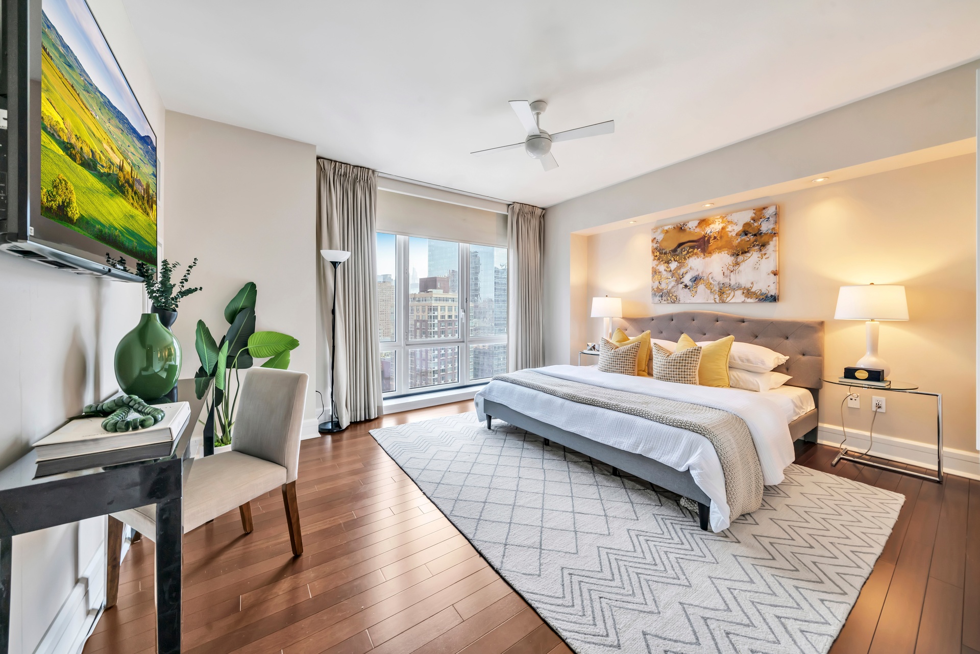 60 Riverside Boulevard, Unit 2402 Manhattan, NY 10069 - Photo 5 of 23 a bedroom with a bed wooden floor and potted plant