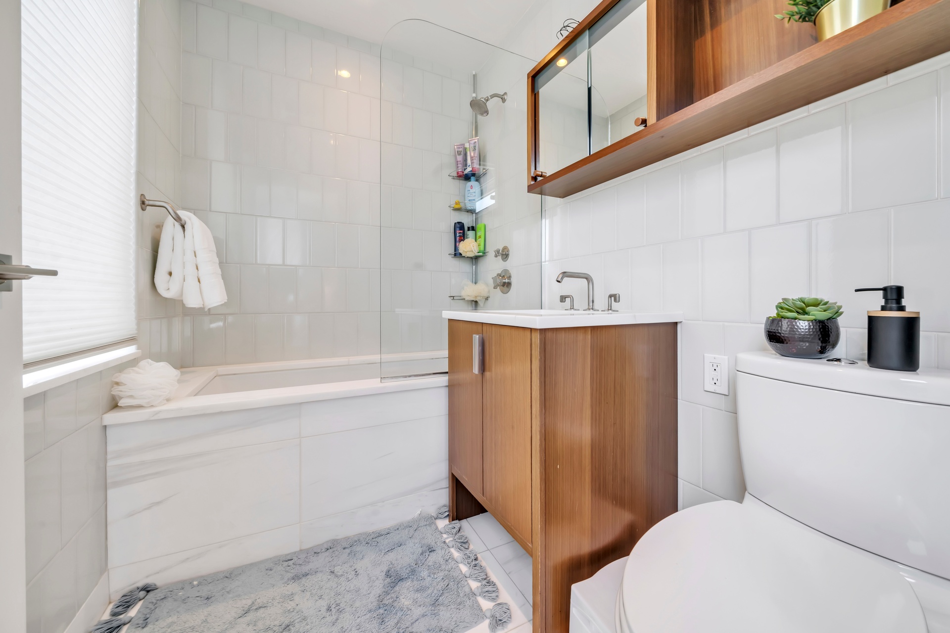 60 Riverside Boulevard, Unit 2402 Manhattan, NY 10069 - Photo 8 of 23 a bathroom with a sink a toilet and shower