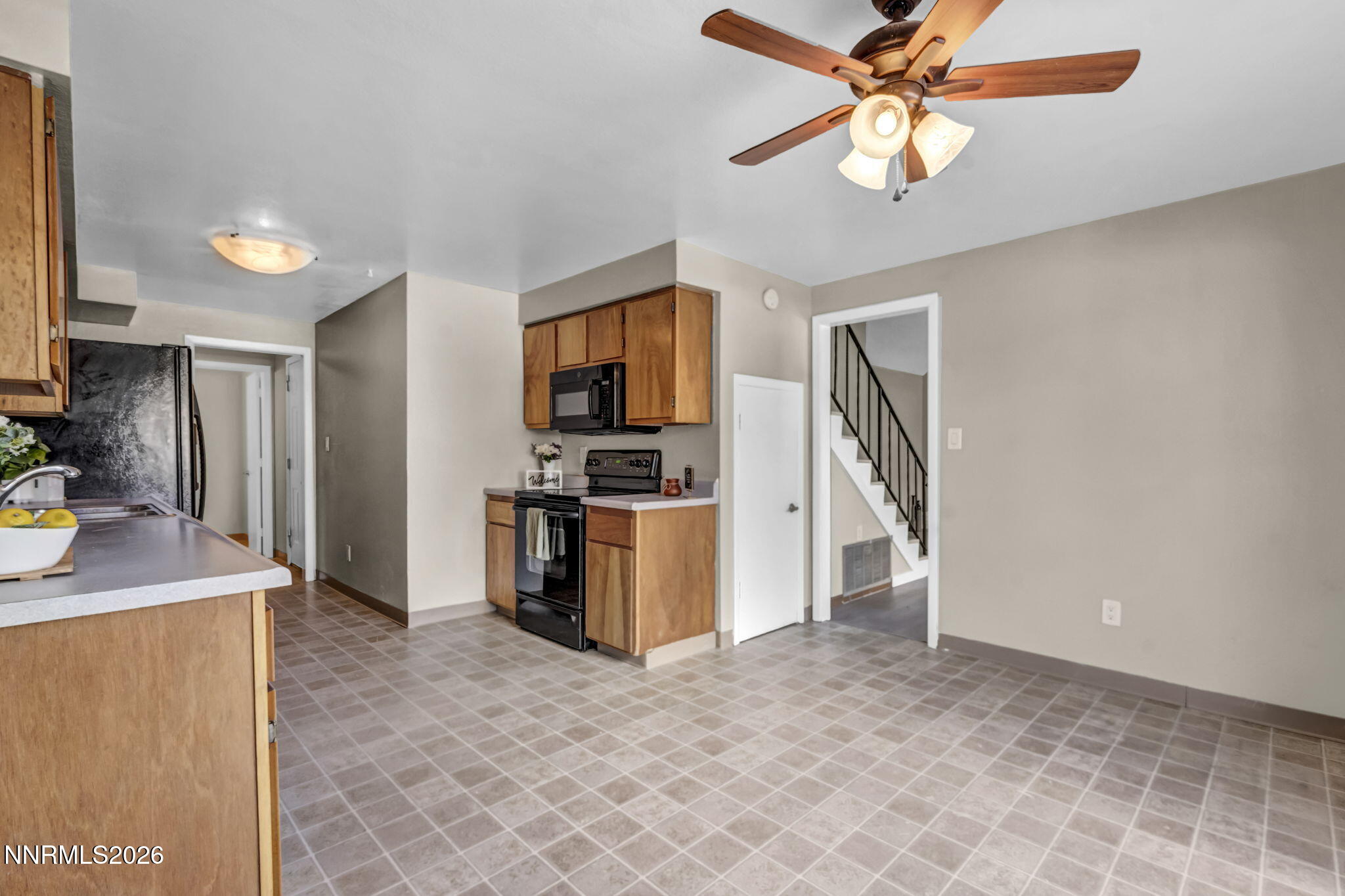 19 Condor Circle Carson City, NV 89701 - Photo 10 of 41 a open kitchen with stainless steel appliances granite countertop a refrigerator a stove a sink a oven with a dining table and chairs